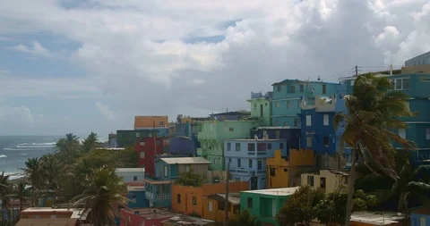 Medium wide angle establishing shot of colorful coastal homes in La Perla Puerto Stock Footage 125112329