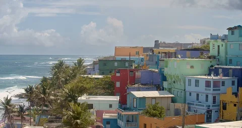 Medium wide angle establishing shot of colorful coastal homes in La Perla Puerto Stock Footage 125112512