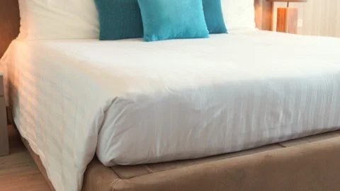 Medium wide pan tilt up shot of a modern freshly made resort hotel double Stock Footage 122022172