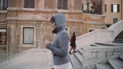 Medium to wide shot on 4k RED camera. Active Italian woman running down the Span Stock Footage 199458937