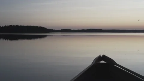 Medium wide shot of the back end of a rowboat on a lake in Finland Stock Footage 113962594