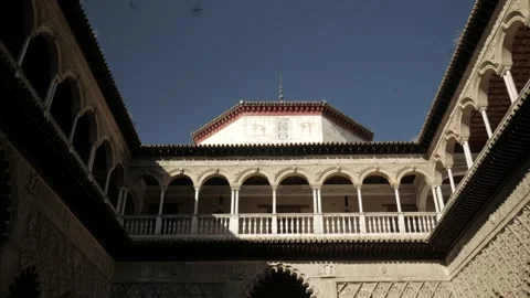 Medium wide shot of brids in the sky against an exterior balcony, in Seville Stock Footage 273582468