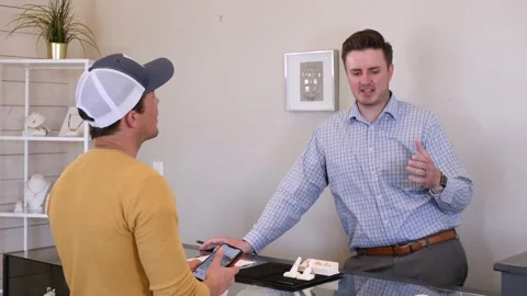 Medium Wide Shot Of A Customer Talking To A Salesman Video stock 133134774