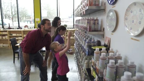 Medium wide shot of a family in a ceramic studio 動画素材 73290578