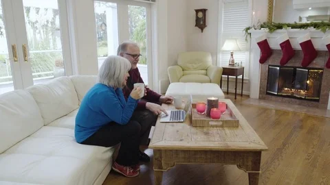 Medium wide shot of an old couple using a laptop 動画素材 73115217