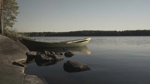 Medium wide shot of a rowboat on a lake in Finland Stock Footage 113872809
