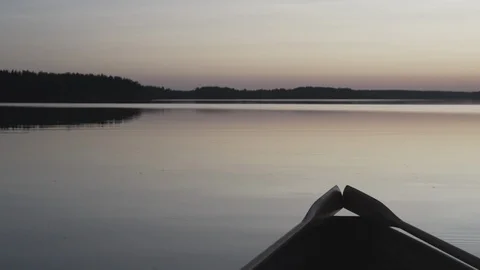 Medium wide shot of the tail end of a rowboat on a lake in Finland Stock Footage 113865057