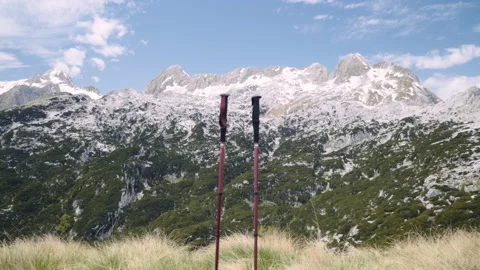 Medium wide static shot, trekking hiking poles, behind mountain with snow. Stock Footage 132232616