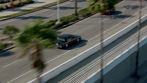 Medium wide tracking erratic police chase from side over bridge 動画素材 136200061