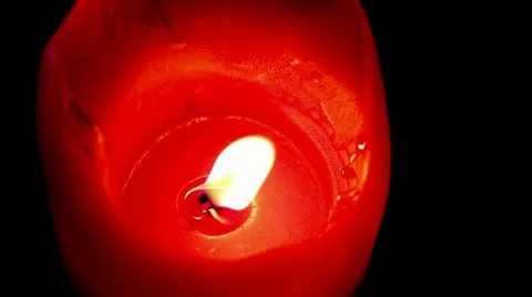 A Medium Zoom of a Red Colored Candle Flame Stock Footage 10947098