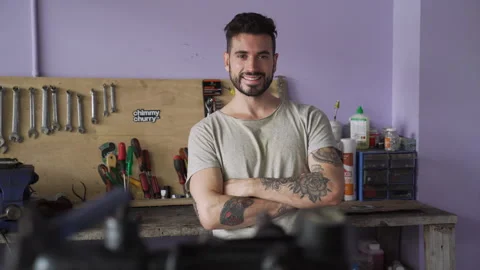 Mediums front view shot of young bicycle mechanic looking confidently at camera Stock Footage 277961114
