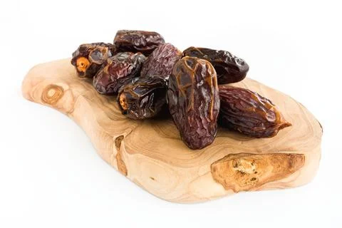 Medjool Dates on an Oak Wood Serving Board Isolated on White Stock Photos
