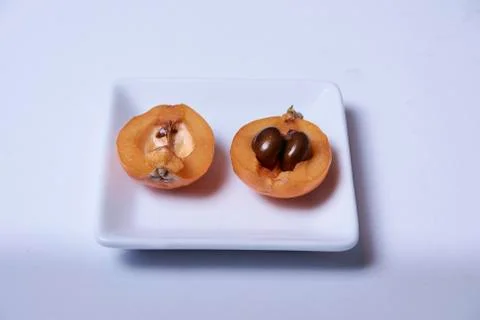 Medlar, split in two halves Stock Photos