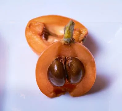 Medlar, split in two halves Stock Photos