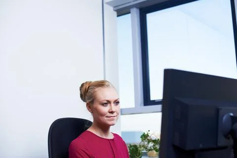 Meeting deadlines is her forte. an attractive businesswoman using her work Stock Photos
