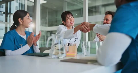 Meeting, doctors and applause with handshake in clinic for hiring success, new Stock Footage 320151755