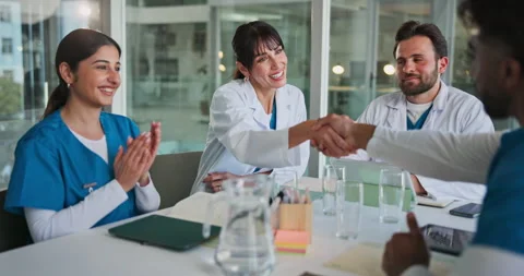 Meeting, doctors and clapping with handshake in clinic for hiring success, new Stockbeeldmateriaal 320282131
