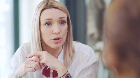 Meeting with friends: beautiful blonde is talking to the other person. Stock Footage