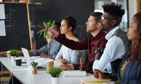 Meeting, pointing or team with feedback in office, creative workshop or ide.. Stock Photos