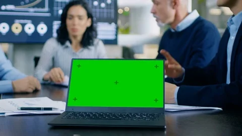 In the Meeting Room Laptop Standing on the Conference Desk Shows Green Screen Stock Footage