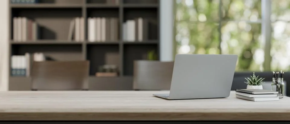 A meeting table features a laptop computer and stuff in a contemporary meet.. Stock Photos