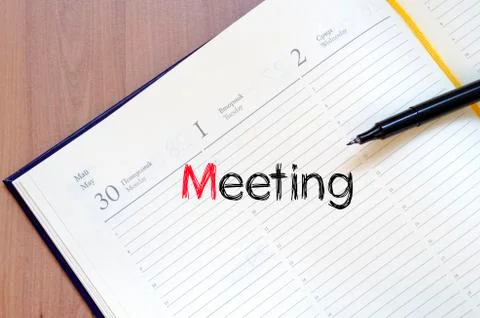 Meeting text concept on notebook Stock Photos