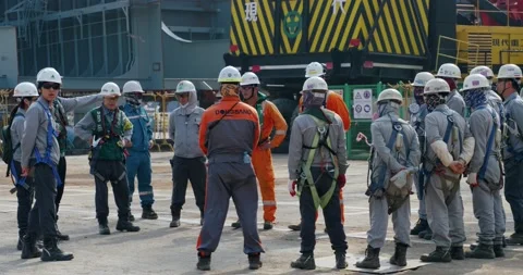 A meeting of workers before the start of a new work shift at the shipyard. Stock Footage 165628821