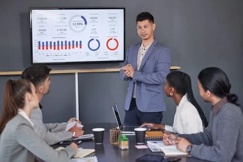 Meetings help keep them all on the same page. a group of businesspeople having a Stock Photos