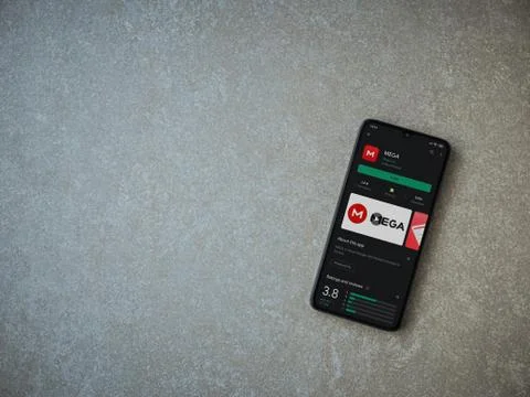 MEGA app play store page on the display of a black mobile smartphone on ceram Stock Photos