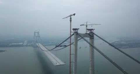Mega bridge construction over the river in China Asia, with stationary boats Stock Footage 92748750