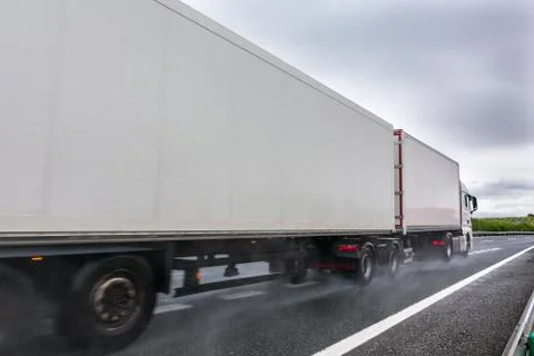 Mega trailer or road train circulating on a day with bad weather due to rain Stock Photos
