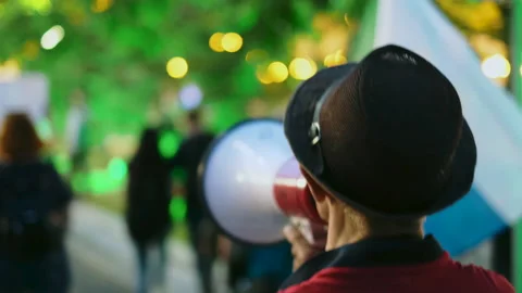 Megaphone activist speaks while marching in political picketing protesters crowd Stock Footage 160922839