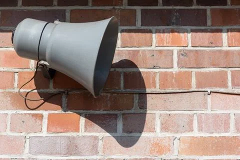 Megaphone in front of an old brick wall Foto stock