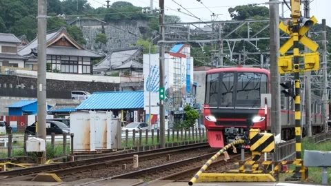 A Meitetsu train passing through a level crossing in Inuyama, Japan Stock Footage 297648965