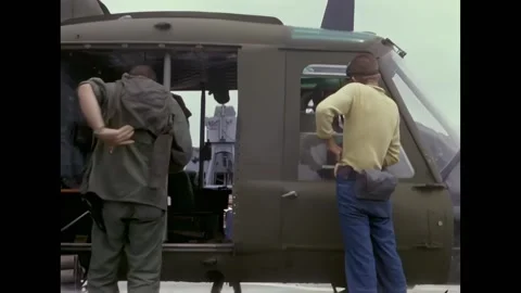 MEKONG DELTA - 1967 - A pilot, copilot, and crewman board a UH-1B helicopter on Stock Footage 337709743