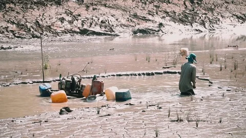 Mekong Delta farmer constructing shrimp farm pond 動画素材 107991599