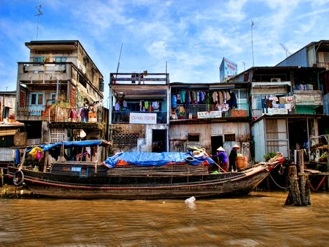 Mekong Delta life on water at river houses slums fishing homesof wood below Stock-Footage 75687853