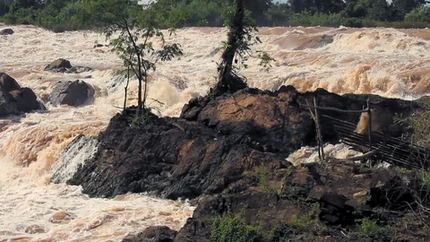 Mekong river rapids, with nets and fishing structures on the side rocks. Video stock 111255144