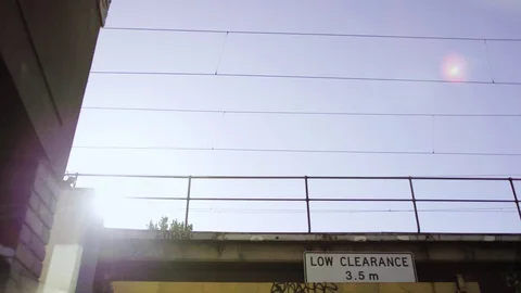 Melbourne Metro train on bridge with sun in slo mo 스톡 동영상 82804022