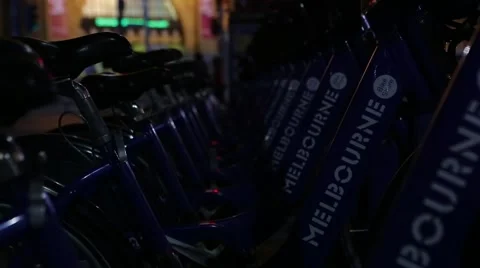 Melbourne rental bicycles night time Stock Footage
