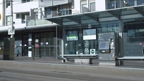 Melbourne- View of tram stop with tram passing by. 4K resolution. Stock Footage 87939603