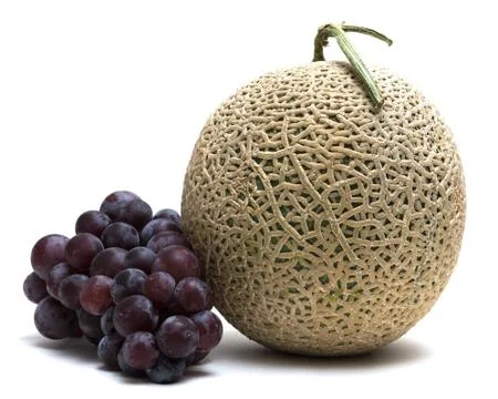 Melon and grape on white background Stock Photos