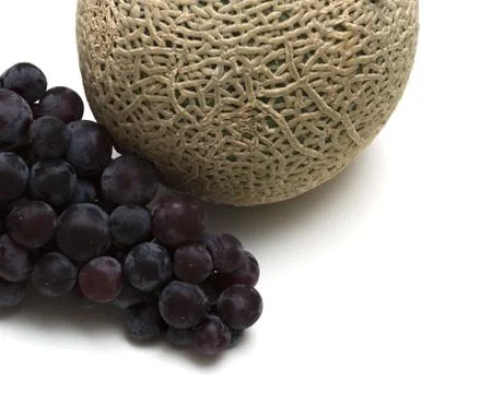 Melon and grape on white background Stock Photos