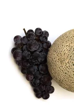 Melon and grape on white background Stock Photos