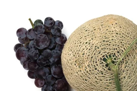 Melon and grape on white background Stock Photos