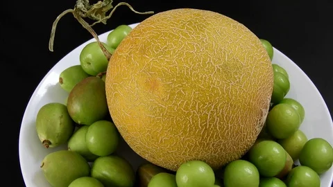Melon and plum and raw nectarine on the rotating stand,a whole melon, green s Stock Footage 129856767