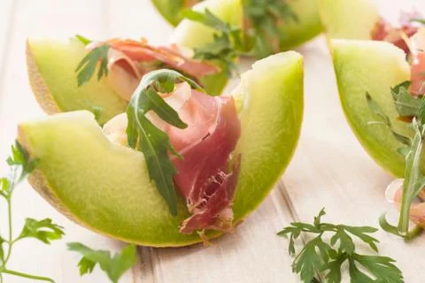 Melon and prosciutto Stock Photos
