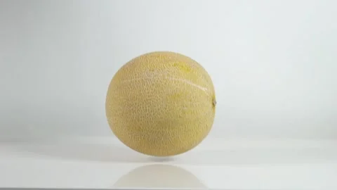 Melon bounces on white table Video stock 145792813
