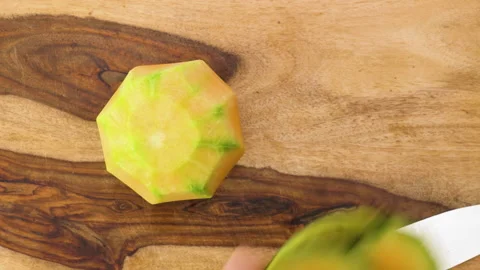 Melon peeling. Close up of cantaloupe melon on wooden background Video stock 142778365