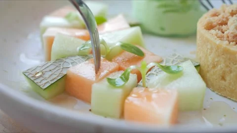 Melon pieces. take pieces of melon with a fork on plate Video stock 156387847